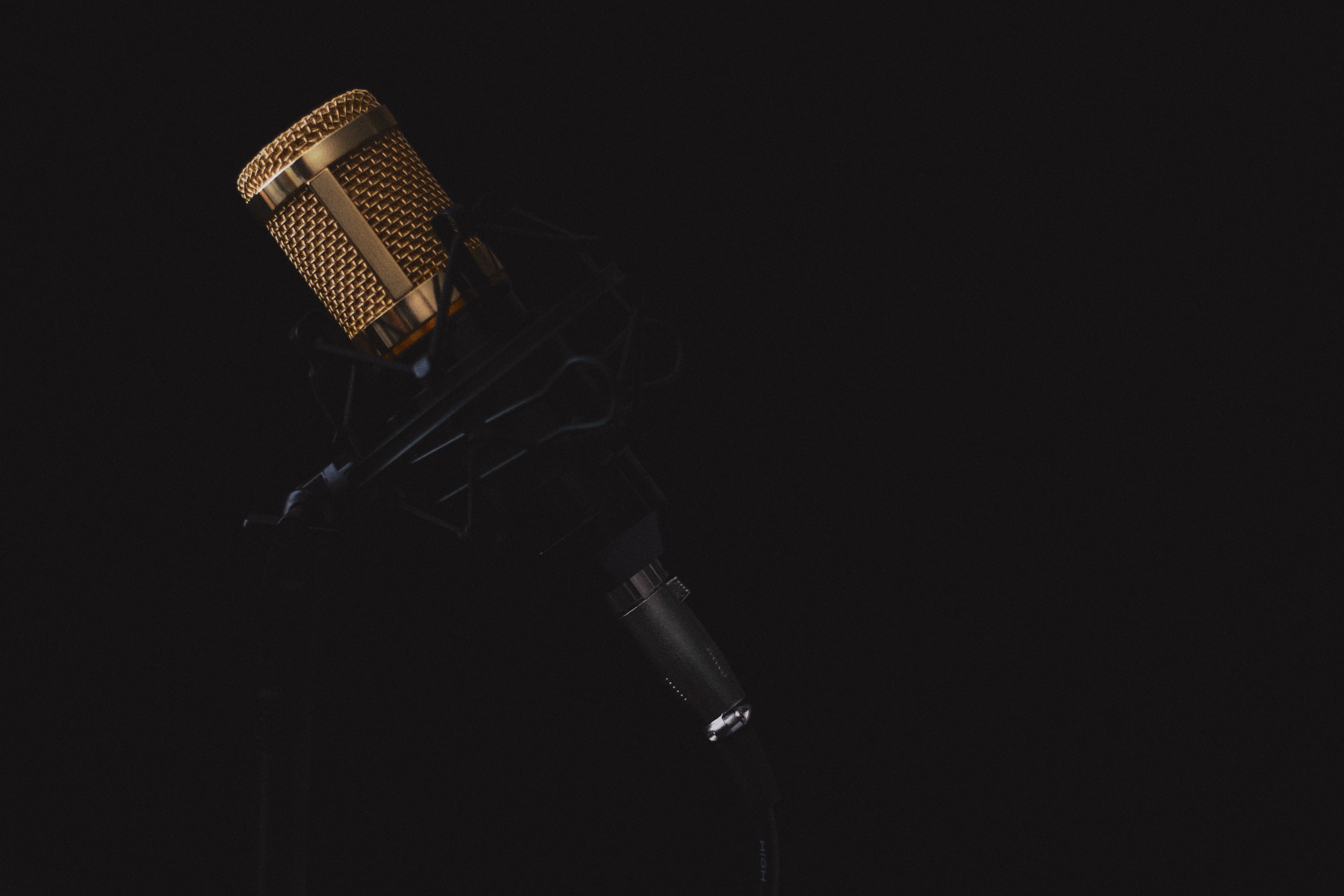 Stock photo — a gold condenser microphone against a dark background (placeholder; swap for real Intentional Studios photography)